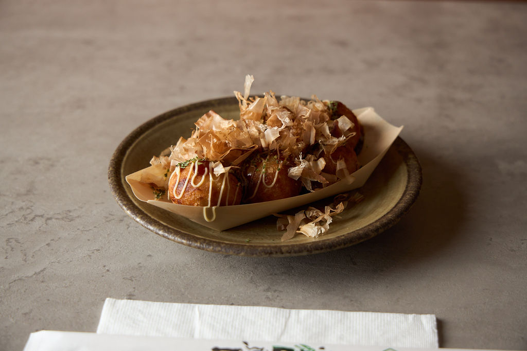 Takoyaki octopus balls with bonito flakes and sauce